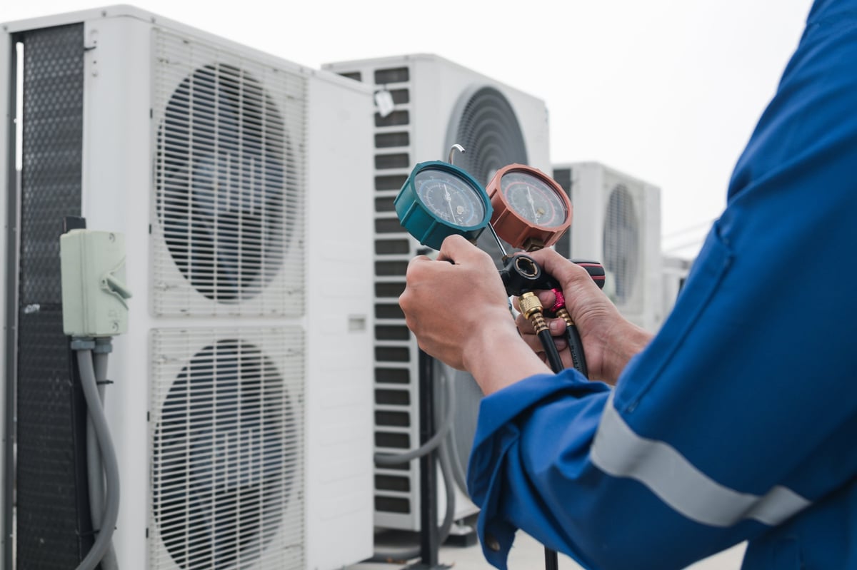 Technician checking air conditioner